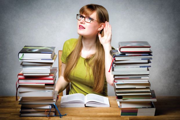 A girl with her hand clasped behind her ear