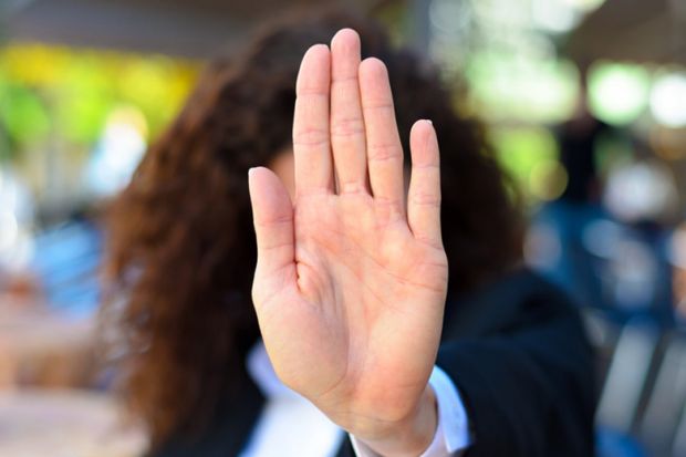 A woman holding up her palm