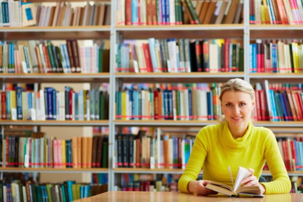 A woman sitting in a library