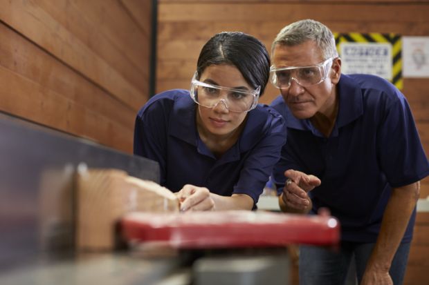 A teacher explains something to an apprentice