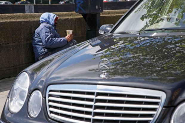 Beggar next to Mercedes