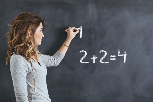 woman writes on blackboard