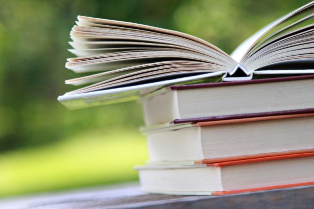 Books open on table outside