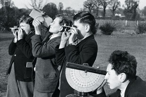 boys practise surveying