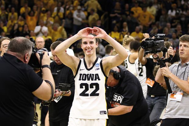 Caitlin Clark #22 of the Iowa Hawkeyes gestures to the crowd as she leaves the court after the game against the West Virginia Mountaineers during their second round match-up in the 2024 NCAA Division 1 Women's Basketball Championship