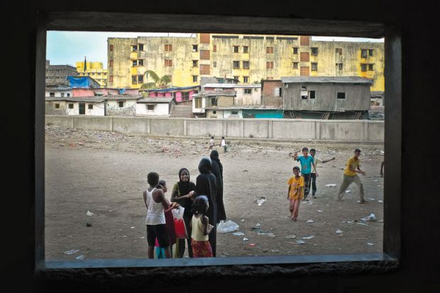 Children playing, viewed through open window, Dharavi, Mumbai