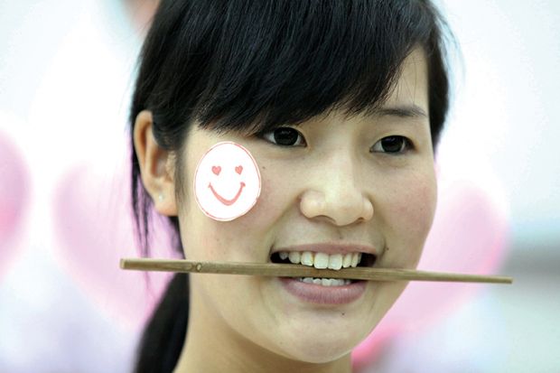 Woman with chopstick in her mouth