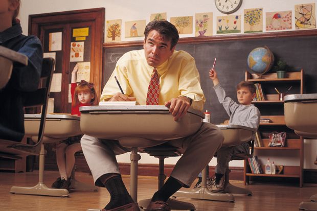 Man sits at child’s desk