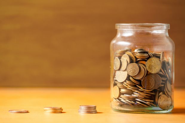 Coins collected in glass jar