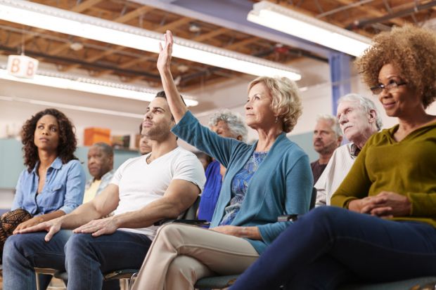 An audience member asks a question at a conference