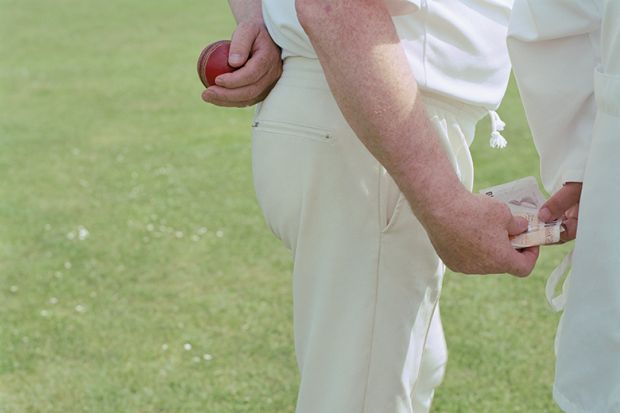 Cricket player and umpire exchanging bribe