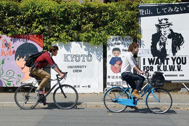 Two young men cycling in Japan