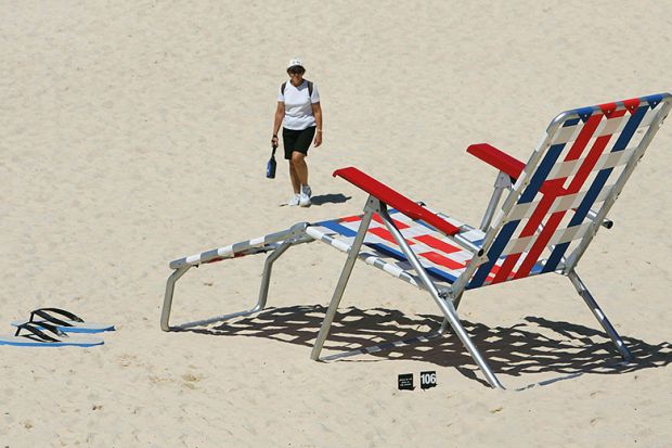 Woman walks near an oversized deckchair artwork ’Recliner Rex’ by New Zealand artist Regan Gentry on Tamarama Beach in Sydney, 2005