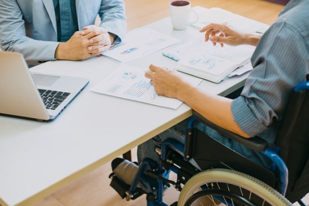 A person in a wheelchair at a job interview