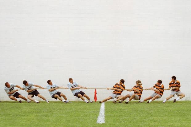 Eight men in tug of war battle