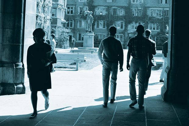 Students walking through an archway