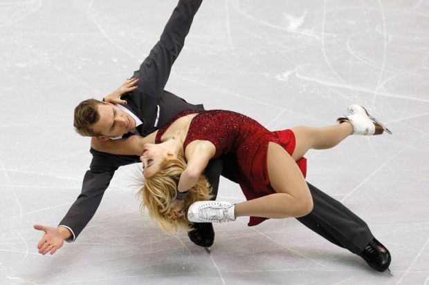 Figure skaters striking pose during competition