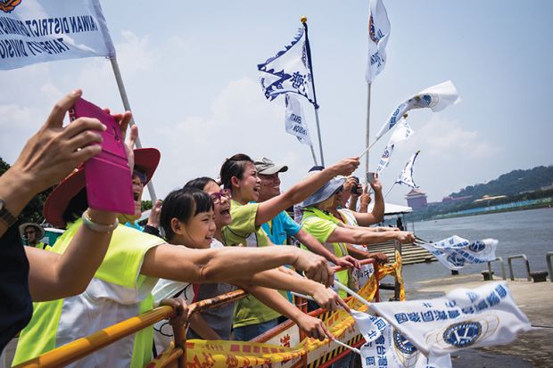 Teammates cheer during a dragon boat race in Taipei