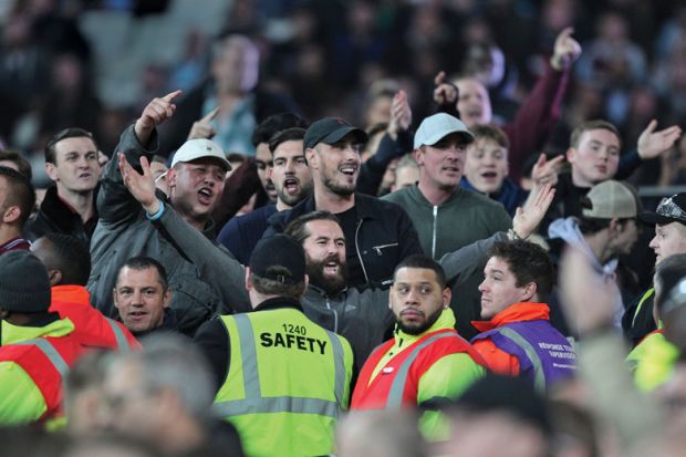 Football fans taunt fans of opposing side