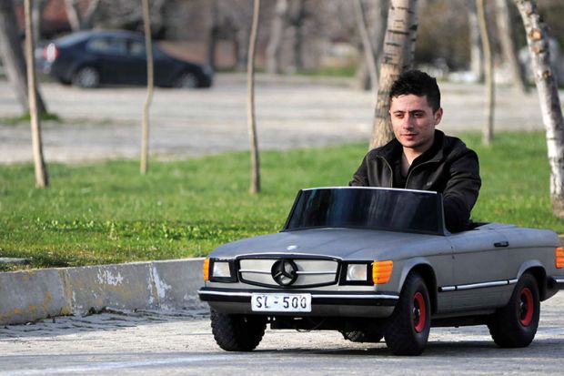 Man driving small car