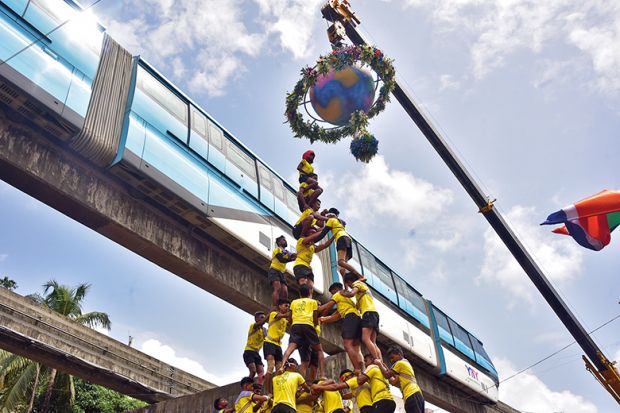 Human pyramid under a globe