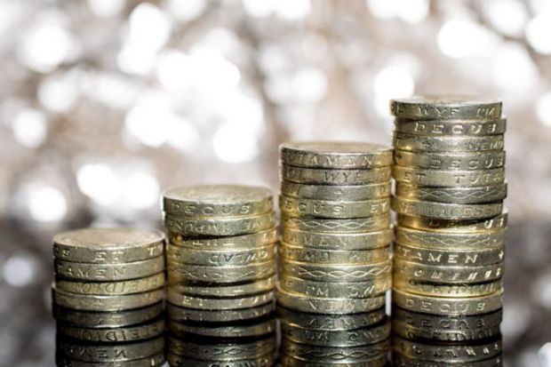 Growing piles of British pound coins