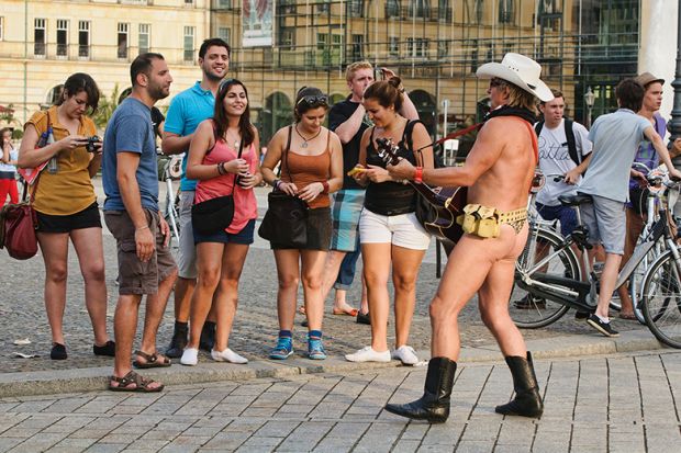 Male guitarist with bare buttocks