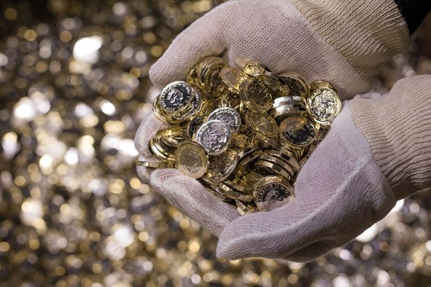 Hand full of pound coins