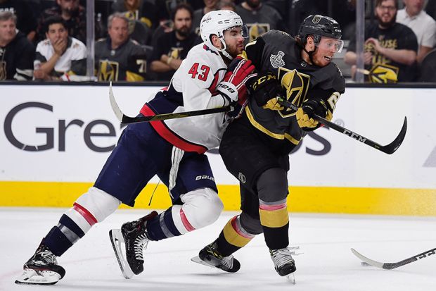 two ice hockey players in tackle