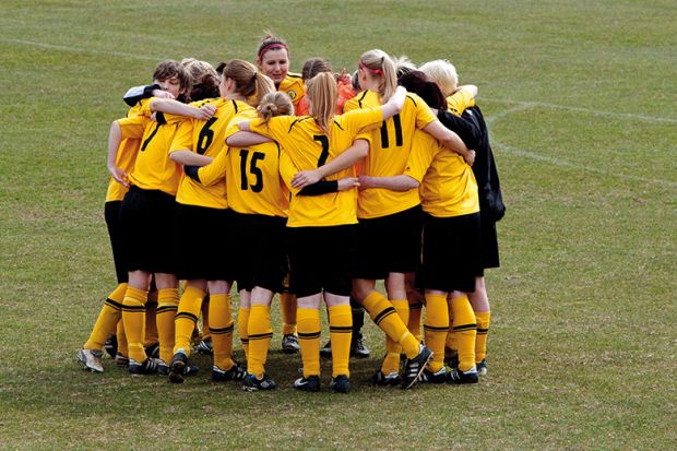 Women`s football team huddle before match