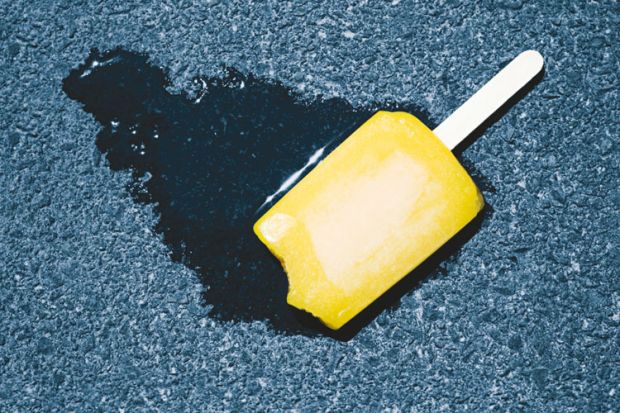 Ice lolly melting on pavement concrete