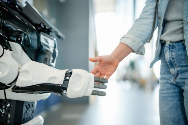 A man shakes hands with a robot