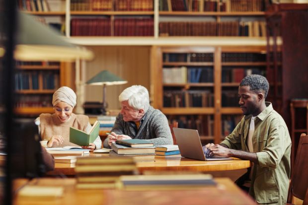 Several people studying in a library