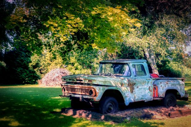 An old pickup truck, in disrepair, sits on the roadside near Manitowoc, Wisconsin