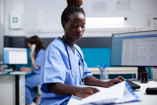 A nurse attends to some paperwork