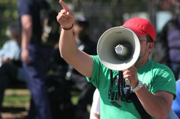 Protester pointing finger and holding megaphone