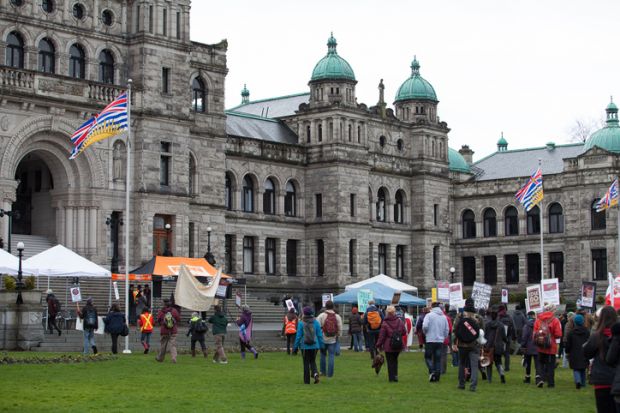 Participants in an Idle No More rally march towards the British Columbia Legislative Building