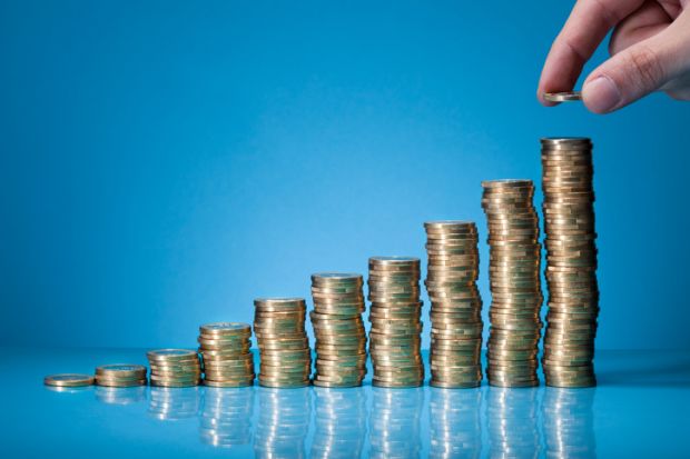 stacks of coins rising in height showing pay and tuition differentials