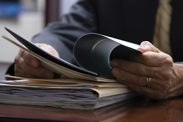 Hands leaf through documents