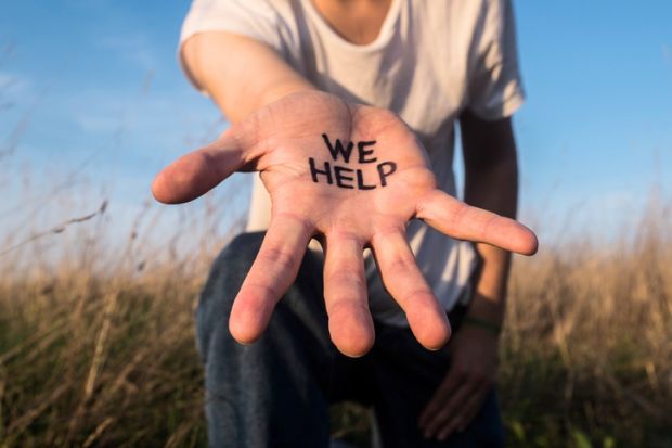 Extended hand with “We help” on the palm, illustrating assistance to international students