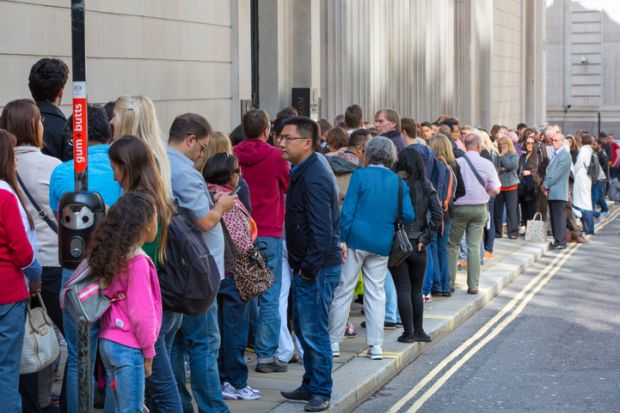 A long queue of people in a street