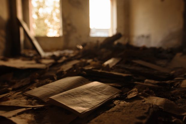 Blurry, darkened room with book open in the foreground