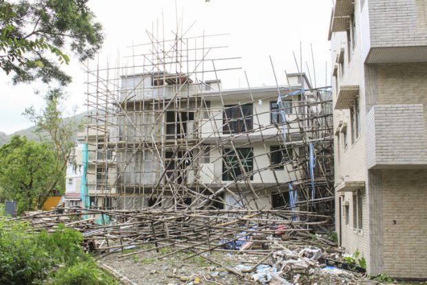 collapse scaffold scaffolding damage destruction construction fall over fall down symbolising collapse of English language colleges