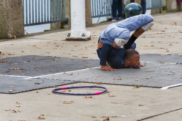 uncomfortable position contortion street performer