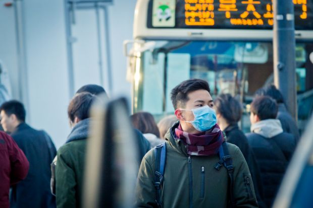 Man wearing mask on the street at rush hour in Japan