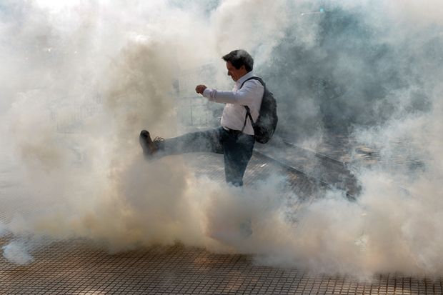 man kicks cloud of smoke