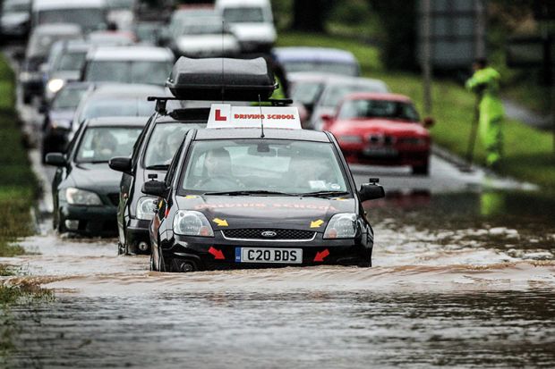 Learned driver on flooded road