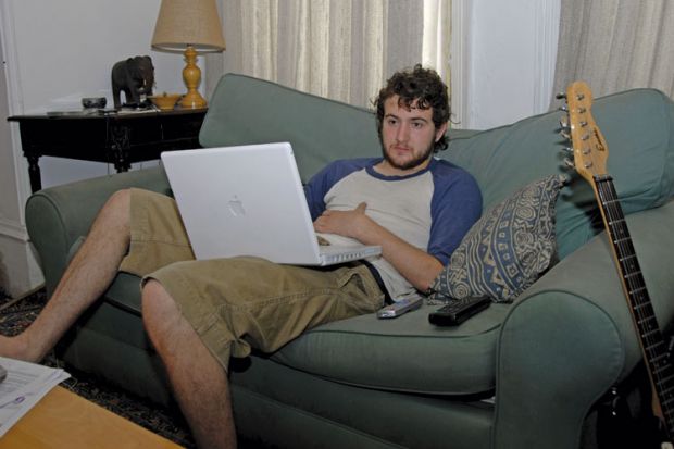 Male student using Apple laptop