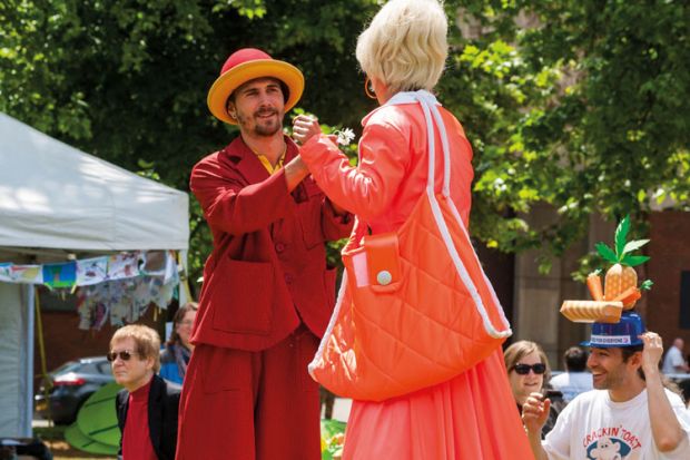 Man and woman dancing wearing stilts