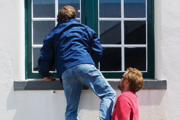 Man being lifted up to look through window